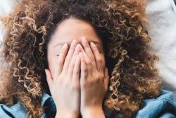 Woman grieving in bed