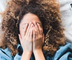 Woman grieving in bed